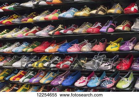 Stock Photography - Display of brightly coloured shoes in a Nao outlet; Torremolinos, Spain. Fotosearch