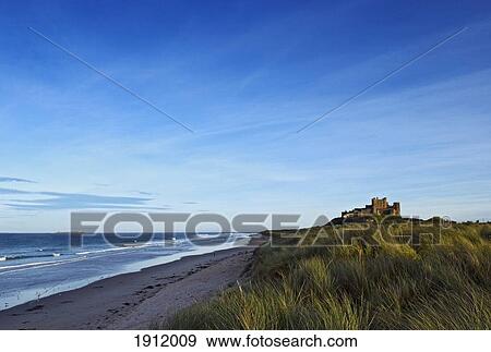 Stock Photo - Distant View Of Bamburgh Castle, Northumberland, England, Uk. Fotosearch
