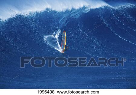 Stock Photo - Distant View Of Windsurfer In Big Blue Wave, Wind Spray Coming Off Tips. Fotosearch