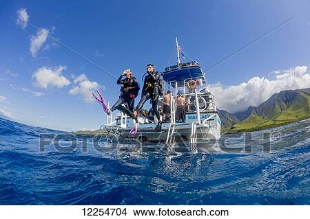 Divers step off a dive boat into the Pacific Ocean out from Ukumehame; Maui, Hawaii, United States of America View Large Photo Image Picture - Divers step off a dive boat into the Pacific Ocean out from Ukumehame; Maui, Hawaii, United States of America. Fotosearch