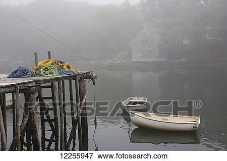 Stock Photo - Dock, lobster trap roping, and boathouse in fog; New Harbor, Maine, United States of America. Fotosearch