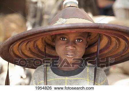 Dogon boy wearing a hat in Tireli, Mali View Large Photo Image Stock Photograph - Dogon boy wearing a hat in Tireli, Mali. Fotosearch