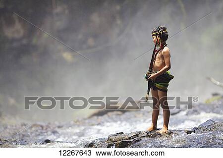 Stock Image - Domestic tourist dressed up as Bunong ethnic minority at Bou Sra Waterfall; Mondulkiri, Cambodia. Fotosearch