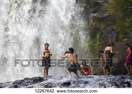 Stock Image - Domestic tourists dressing up as Bunong ethnic minority at Bou Sra Waterfall; Mondulkiri, Cambodia. Fotosearch