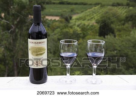 Stock Image - Don Humberto Carmenere Wine Bottle And Glasses, Calamuchita, Tarija, Bolivia. Fotosearch