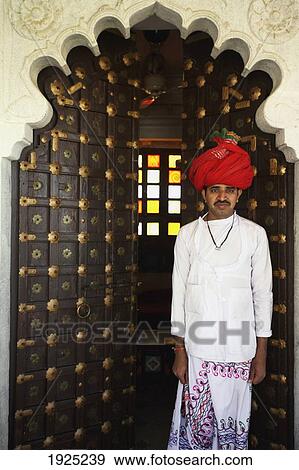Stock Photo - Dorrman Outside Rawla Narlai Hotel; Rajasthan, India. Fotosearch