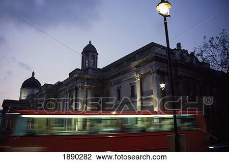 Stock Image - Double Decker Bus Passing National Gallery At Dusk. Fotosearch