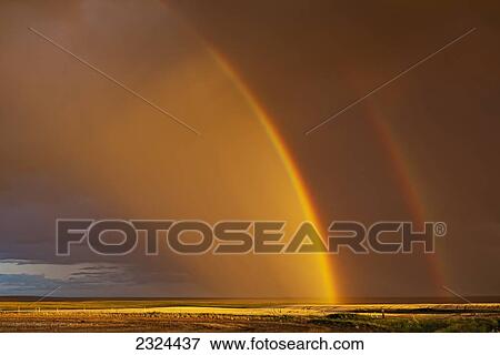 Stock Photo - Double rainbow over a prairie field after a storm; Val Marie, Saskatchewan, Canada. Fotosearch