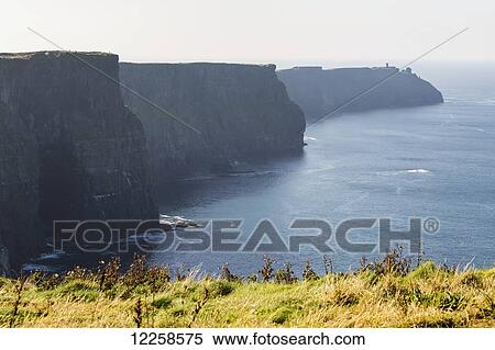 Dramatic straight rock cliffs along shoreline; Liscannor, County Clare, Ireland View Large Photo Image Stock Photography - Dramatic straight rock cliffs along shoreline; Liscannor, County Clare, Ireland. Fotosearch