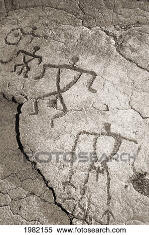 Stock Photography - Drawings of human figures on a rock surface. Fotosearch