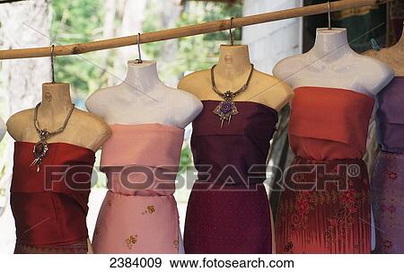 Stock Photo - Dresses for sale on mannequins; Laos. Fotosearch