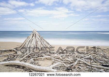 Stock Image - Driftwood structures along a beach; Wailua, Kauai, Hawaii, United States of America. Fotosearch