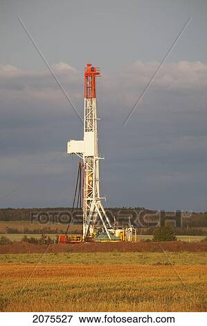 Drilling Rig In A Field Dramatically Lit At Sunrise; Alberta Canada View Large Photo Image Stock Photo - Drilling Rig In A Field Dramatically Lit At Sunrise; Alberta Canada. Fotosearch