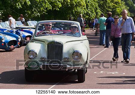 Stock Image - Drivers starting off from Greenwich Park on the London to Brighton Vintage Car Rally; London, England. Fotosearch
