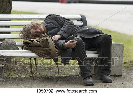 Stock Image - Drunk Man On A Park Bench In Tallinn, Estonia. Fotosearch