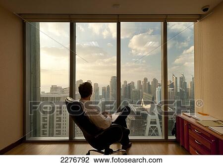 Dubai Marina, Dubai, Uae. Man In Office Looking Out From Large Windows To Office And Residential Tower Blocks In Dubai Marina View Large Photo Image Stock Image - Dubai Marina, Dubai, Uae. Man In Office Looking Out From Large Windows To Office And Residential Tower Blocks In Dubai Marina. Fotosearch