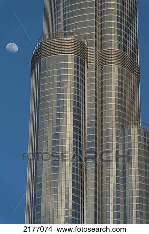 Picture - Dubai, Uae. Detail Of The Burj Khalifa With Moon Rising Behind. Fotosearch