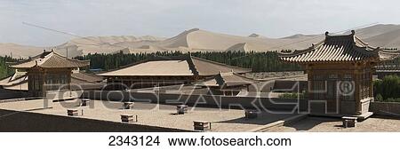 Dun Huang Silk Road Hotel With Singing Sand Mountain In The Background; Jiuquan, Gansu, China View Large Photo Image Picture - Dun Huang Silk Road Hotel With Singing Sand Mountain In The Background; Jiuquan, Gansu, China. Fotosearch