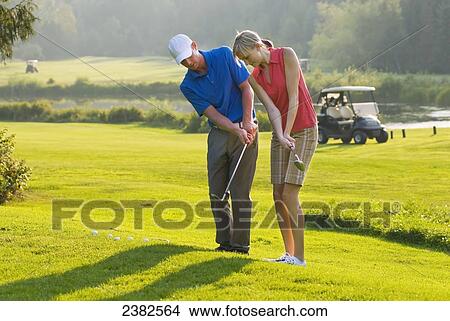 Picture - Duncan Savage, golf pro, teaches a lesson at the Whistler Golf Course; Whistler, British Columbia, Canada. Fotosearch
