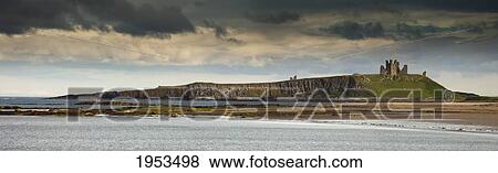 Dunstanburgh Castle On A Hill Under A Cloudy Sky; Bamburgh Northumberland England View Large Photo Image Stock Photo - Dunstanburgh Castle On A Hill Under A Cloudy Sky; Bamburgh Northumberland England. Fotosearch