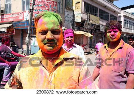 Stock Image - During coloured dye throwing Holi festival, Jaipur, capital of Rajasthan, India. Indian festival of Holi, traditionally when India celebrated the end of winter and the beginning of Spring. March. Jaipur, Rajasthan State, India.. Fotosearch