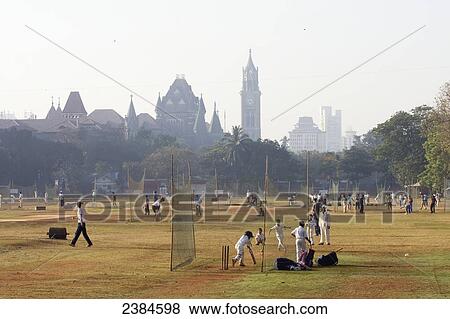 Early morning games of cricket and in the nets at Cross Maiden with Law Courts in background; Mumbai, Maharashtra State, India View Large Photo Image Stock Photo - Early morning games of cricket and in the nets at Cross Maiden with Law Courts in background; Mumbai, Maharashtra State, India. Fotosearch