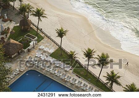 Stock Image - Early morning view of the pool and beach at Sheraton hotel, Leblon; Rio de Janeiro, Brazil. Fotosearch