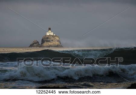 Stock Photography - Early sunlight illuminates the old Tillamook Rock Lighthouse; Cannon Beach, Oregon, United States of America. Fotosearch