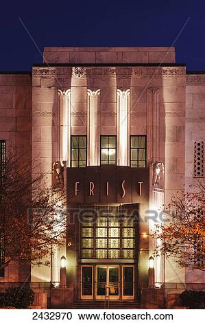 Stock Image - East front entry door of the Frist Center for the Visual Arts building at twilight, the museum is housed in the old Main Post Office on Broadway Street; Nashville, Tennessee, United States of America. Fotosearch