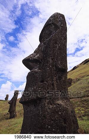 Stock Image - Easter Island, Close-up of Moai statue on grassy hillside; Rano Raraku Area. Fotosearch