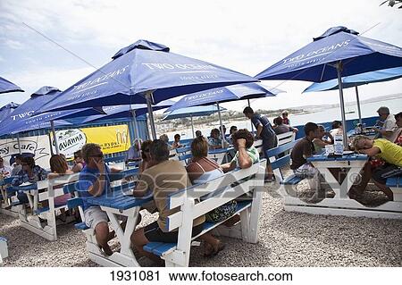 Stock Image - Eating Outdoors And Sea Gypsy, Mossel Bay, South Africa; Eating Outdoors And Sea Gypsy, Mossel Bay, South Africa. Fotosearch