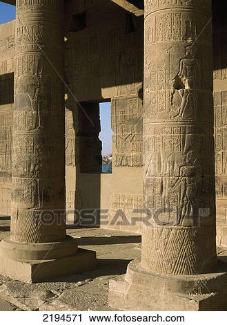 Stock Image - Egypt, Aswan, Temple of Isis; Philae Island, Looking through window to Lake Nasser in West Colonnade covered in reliefs and hieroglyphs. Fotosearch