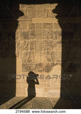 Stock Photo - Egypt, Aswan, West Colonnade of Temple of Isis; Philae Island, Shadow of woman taking photographs and columns. Fotosearch