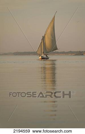 Stock Photo - Egypt, Felucca on River Nile at dusk; Aswan. Fotosearch