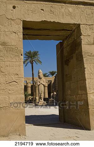 Stock Photo - Egypt, Karnak Temple; Luxor, Looking through doorway of Temple of Ramses III to Colossus of Ramses II in forecourt of precinct of Amun. Fotosearch