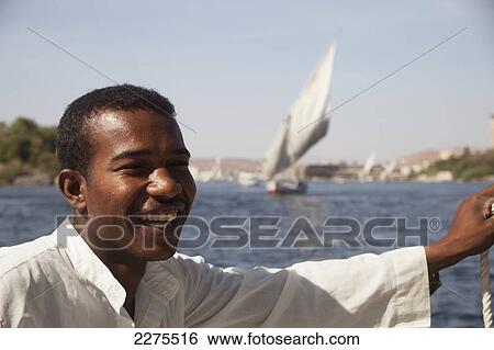 Egypt, Nubian Boatman Sailing Felucca On River Nile; Upper Egypt View Large Photo Image Stock Photograph - Egypt, Nubian Boatman Sailing Felucca On River Nile; Upper Egypt. Fotosearch