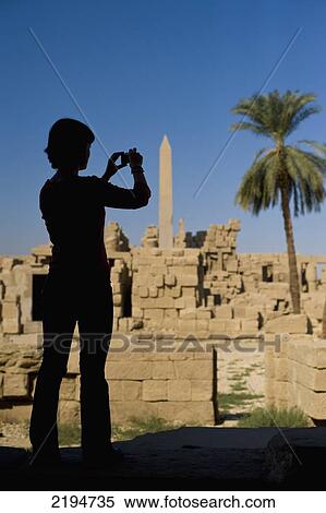 Egypt, Precinct of Amun; Luxor, Silhouette of woman photographing ruins of Karnak Temple View Large Photo Image Stock Photography - Egypt, Precinct of Amun; Luxor, Silhouette of woman photographing ruins of Karnak Temple. Fotosearch