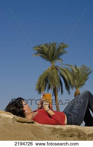 Egypt, Precinct of Amun; Luxor, Woman reading guidebook to Egypt on old wall of Karnak Temple View Large Photo Image Stock Photograph - Egypt, Precinct of Amun; Luxor, Woman reading guidebook to Egypt on old wall of Karnak Temple. Fotosearch