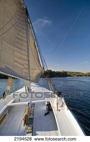 Egypt, Woman relaxing on deck of felucca going down River Nile; Aswan View Large Photo Image Stock Photo - Egypt, Woman relaxing on deck of felucca going down River Nile; Aswan. Fotosearch