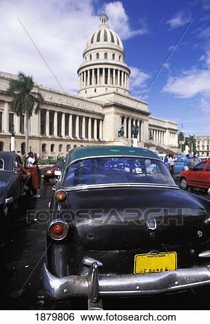 Stock Photograph - El Capitolio With Old American Cars. Fotosearch