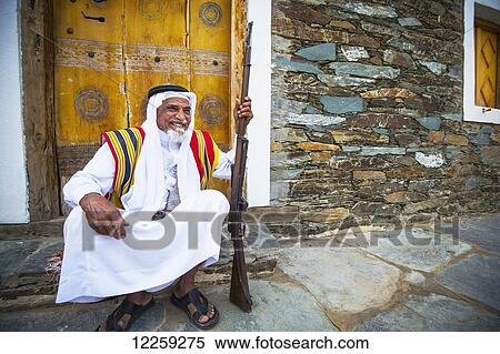 Elderly man and musket relaxing, near Rijal Alma village; Asir Province, Saudi Arabia View Large Photo Image Stock Photography - Elderly man and musket relaxing, near Rijal Alma village; Asir Province, Saudi Arabia. Fotosearch
