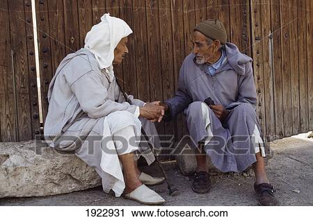 Stock Image - Elderly Men Talking On Street. Fotosearch