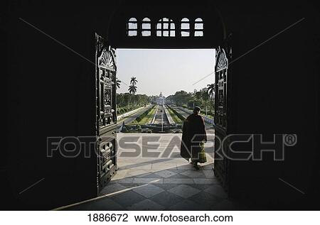 Stock Image - Elderly Woman Exiting Ujjayanta Palace. Fotosearch