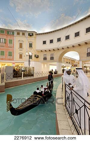 Stock Image - Electric gondola on canal in the Villagio shopping mall; Doha, Qatar. Fotosearch