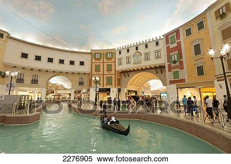 Stock Photography - Electric gondola on canal in the Villagio shopping mall; Doha, Qatar. Fotosearch