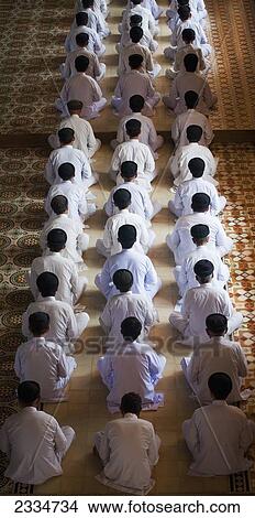 Picture - Elevated View Of Praying Men; Saigon, Vietnam. Fotosearch