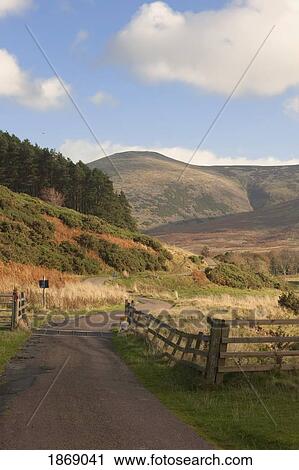 Stock Image - Elsdon Burn, Northumberland, England; A Rural Road. Fotosearch