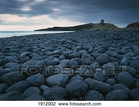 Stock Image - Embleton Bay And Dunstanburgh Castle In Distance, Night, Northumberland, England, Uk. Fotosearch