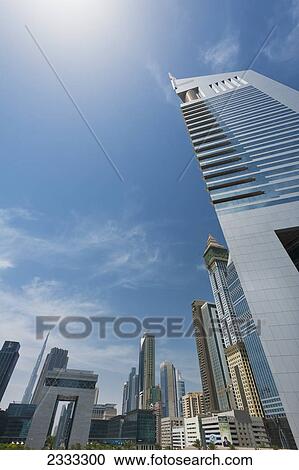 Stock Image - Emirates Tower With Difc (Dubai International Financial Centre) In Background; Dubai, United Arab Emirates. Fotosearch
