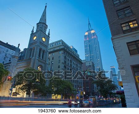 Stock Image - Empire State Building And Collegiate Reformed Church On Fifth Avenue; New York City New York United States Of America. Fotosearch